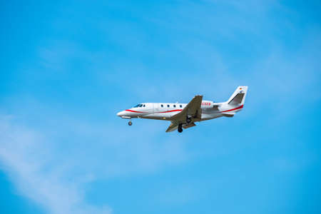 Zurich, Switzerland - July 19, 2018: Small private jet airplane preparing for landing at day time in international airportのeditorial素材