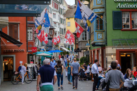Zurich, Switzerland - July 20, 2018: Tourists visit old city pedestrian street and eat at restaurantのeditorial素材