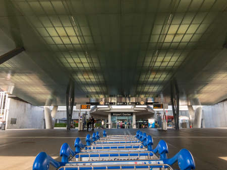 Zurich, Switzerland - July 22, 2018: Luggage trolleys in front of the airport building