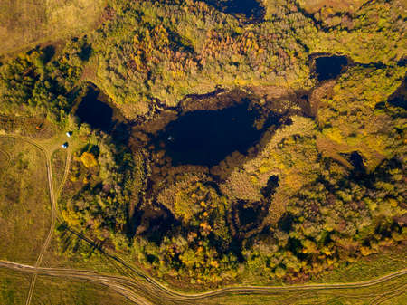 Aerial landscape of a lake in the forest at summer, fisherman in the boat