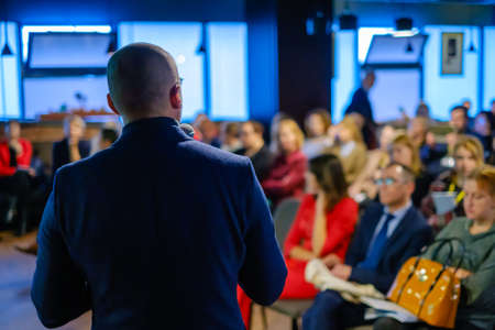 Male presenter speaks to audiences at workshopの写真素材