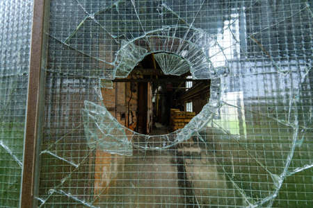Broken glass in the window of industrial warehouseの写真素材