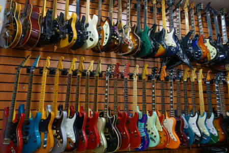 Moscow - November 15, 2019: Different electric guitars hang in the music instruments store for sale