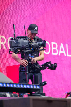 Saint Petersburg, Russia - October 4, 2019: Steadicam camera man online broadcasting from stageのeditorial素材