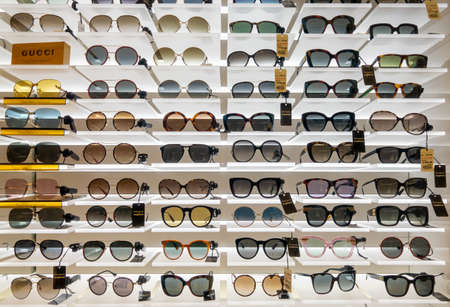 Heathrow, Britain - August 15, 2019: Designer sunglasses for sale in duty free store at airportのeditorial素材