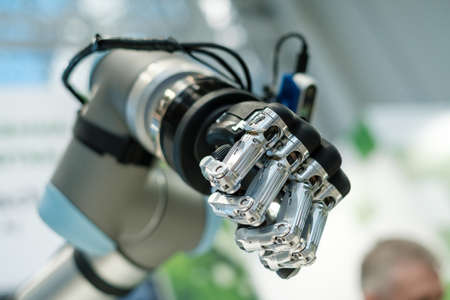 Robotic cyborg automated hand made with steel and black plastic as part of machine toolの写真素材