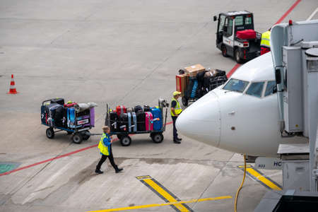 Zurich, Switzerland - July 19, 2018: Loader carries passengers luggage at the airportのeditorial素材