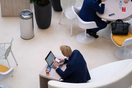 Businessman working on laptop top viewの写真素材