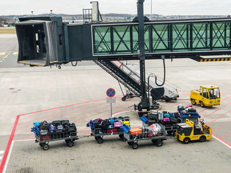 Zurich, Switzerland - July 19, 2018: Loader carries passengers luggage at the airport