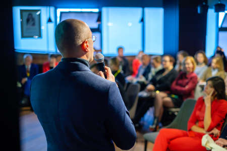 Male presenter speaks to audiences at seminarの写真素材