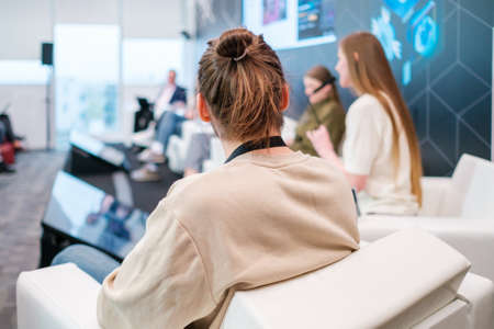 Unrecognizable man listening to speaker during business seminarの写真素材