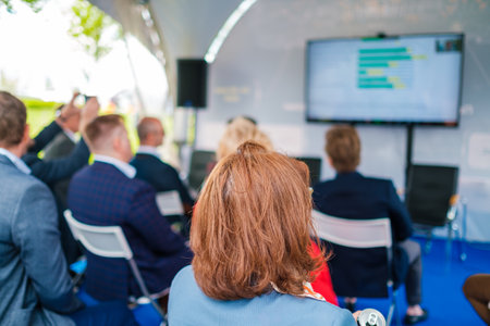 Participants of open air conference listening to speakerの写真素材