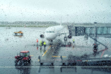 Airport aerodrome behind wet glass