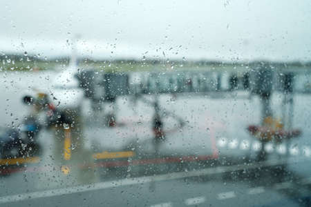Airport aerodrome behind wet glassの写真素材