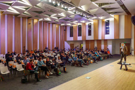 Speaker on stage in auditorium