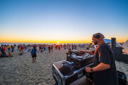People on sandy beach during party in eveningのeditorial素材