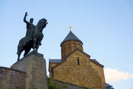 Equestrian statue near old church