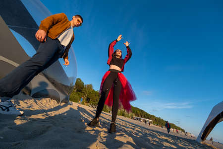 Delighted people dancing on beach