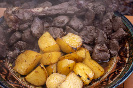 Plate with fried potatoes and meatの写真素材