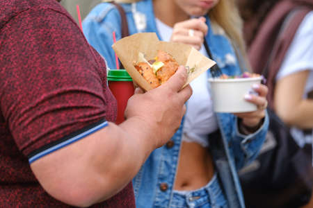 Crop people eating food to goの写真素材