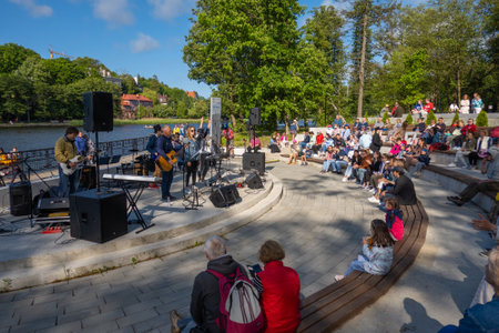 Musicians and audience on embankment