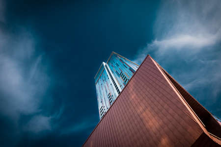 Contemporary skyscraper against stormy skyの写真素材