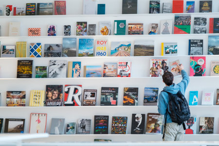 Unrecognizable man picking book from shelfのeditorial素材