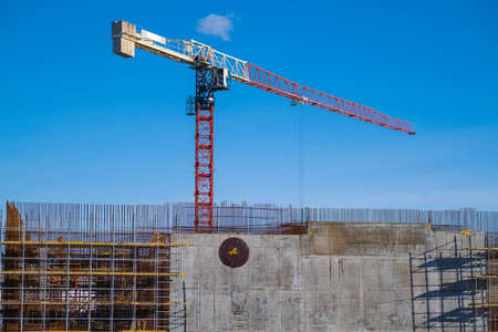 Cranes building structure against blue sky