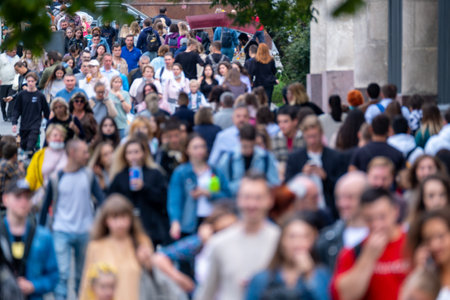 Crowd of unrecognizable people walking along streetの写真素材