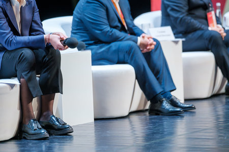 Crop speakers sitting on stageの写真素材