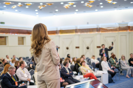 Speaker on stage communicating with conference participantsの写真素材