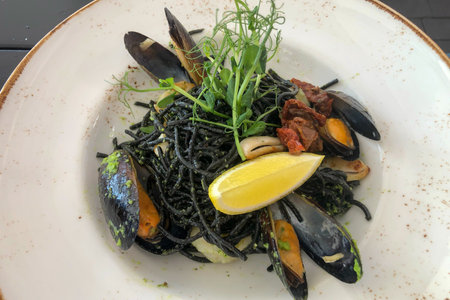 Black mussel pasta with lemon and herbsの写真素材