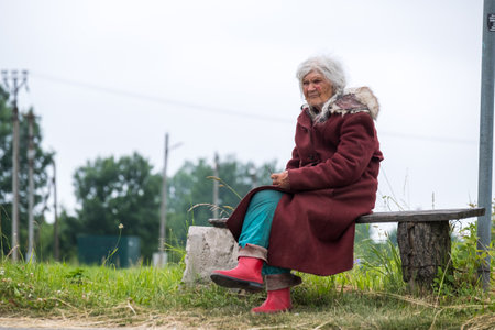 Elderly woman sitting on benchのeditorial素材