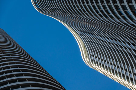 Curvy skyscrapers against blue skyの写真素材
