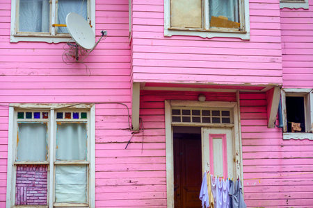 Facade of shabby house in bright pink colorの写真素材