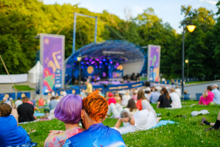 Woman dancing during concert against neon lightの写真素材