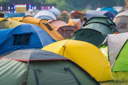 Multicolored tents on music festival campsite at park