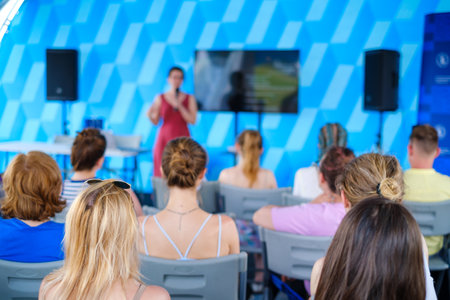 Viewers during presentation of blurred womanの写真素材