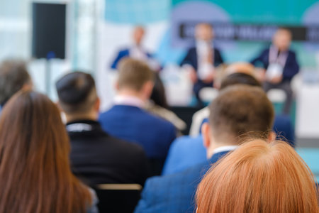Anonymous businessmen talking during presentation in conference centerの写真素材