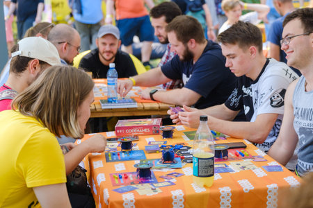 Vilnius, Lithuania - September 12, 2023: Happy young people gathering around table and playing board...
