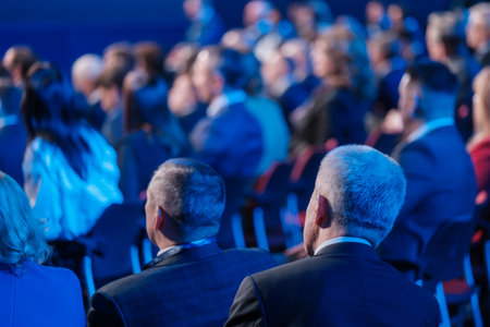 Back view of businessmen attending conference meeting in auditorium at export forumの写真素材