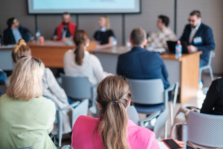 Businesswomen attending conference meeting with colleagues in boardroom at officeの写真素材