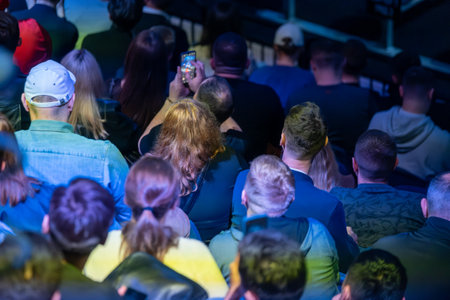 High angle view of businesspeople attending concert in stadiumの写真素材