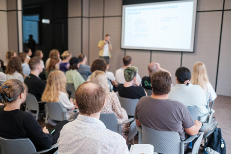 Professional presentation in conference setting with audience engaged in learning and discussionの写真素材