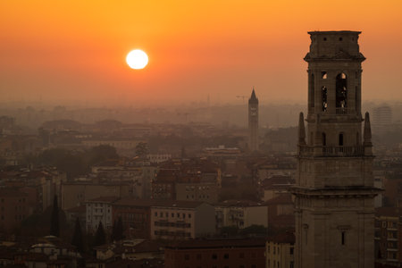 Golden sunset illuminates Verona skyline, highlighting iconic architecture and warm hues. Scenic urban panorama captures historic charm and tranquil evening ambiance.の写真素材