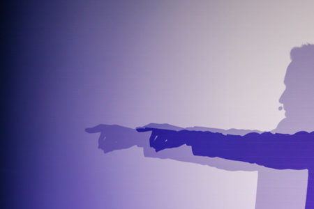 Silhouette with dramatic shadows on purple gradient background depicting pointing gesture and...