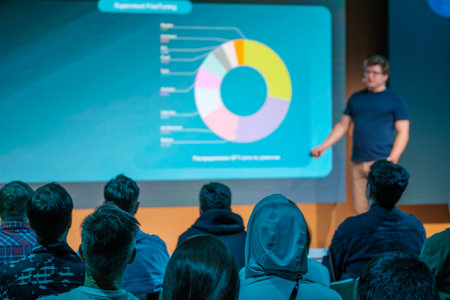 Conference presentation on data analytics with audience viewing detailed chart displayed on screenの写真素材