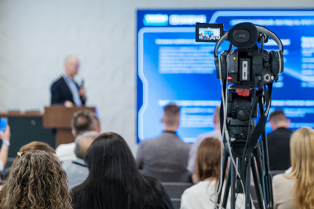 Event showcasing speaker delivering presentation to audience, recorded with professional video...