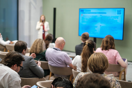 Attentive audience during a professional presentation, capturing engagement and focus in a business...