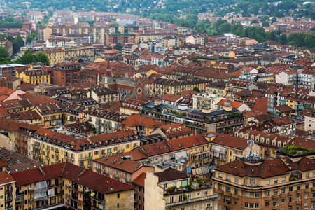 Dense residential cityscape of Torino, Italy with red tiled roofs and building structures in urban Italy.の写真素材